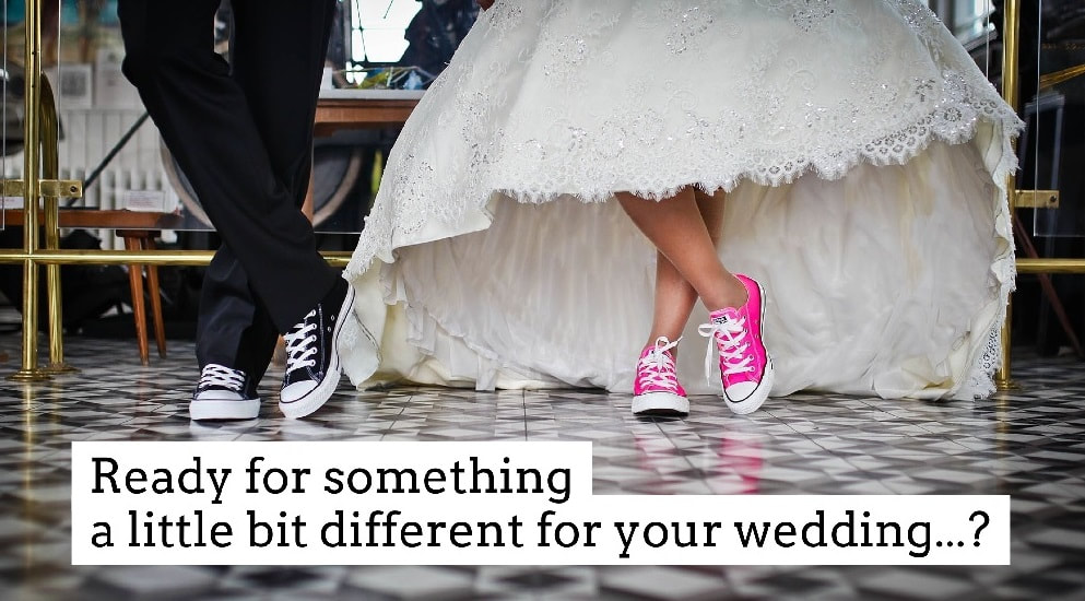 bride and groom with colourful converse trainers on